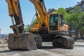 Excavator and his bucket at the construction site of a new road - PhotoDune Item for Sale