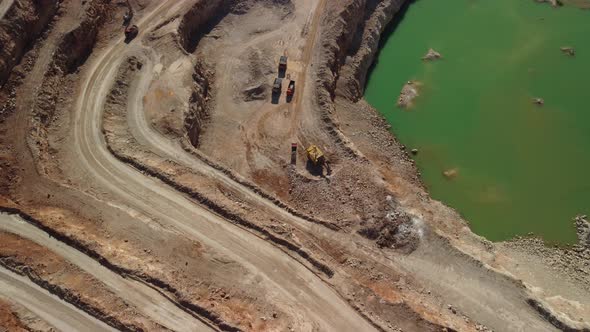 Aerial View of Industrial Opencast Mining Quarry with Lots of Machinery at Work Extracting Fluxes