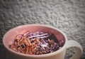 a coffee mug full of purple and gold paper clips and office supplies sits on a desk.  - PhotoDune Item for Sale