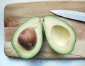Avocado on the cutting board and knife. - PhotoDune Item for Sale