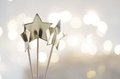 Three gold colored stars against the bokeh glitter background. - PhotoDune Item for Sale