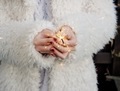 Young woman in white furred coat holding burning sparkler in her hands. New year's celebration. - PhotoDune Item for Sale