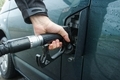 Close up of man's hand holding fuel pump and refueling the car. - PhotoDune Item for Sale