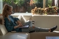 Girl sitting on the white couch and using her laptop. - PhotoDune Item for Sale