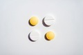White and yellow pills organized on the white background.  - PhotoDune Item for Sale