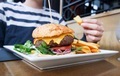 Eating big hamburger with french fries. - PhotoDune Item for Sale