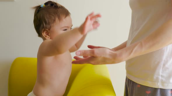 Close Up of a Happy Baby Girl Playing with Cute Mother's Hands