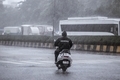 Man riding a two wheeler in heavy rains - PhotoDune Item for Sale