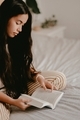 Young Asian Woman Reading a Book on her Bed - PhotoDune Item for Sale