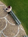 Abstract view from above of grass,  pavement and bench. Woman sitting on the bench and using phone. - PhotoDune Item for Sale