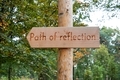 Path of reflection written on the direction sign in the woods.  - PhotoDune Item for Sale