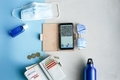 Travel items flat lay on blue and grey background - PhotoDune Item for Sale