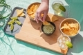 Latino table . Person eating nachos with guacamole.  - PhotoDune Item for Sale