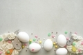 White eggs with the colorful spring sprinkles and decorative sheep on the white background - PhotoDune Item for Sale