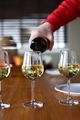 Hand pouring white wine in to the glass. - PhotoDune Item for Sale
