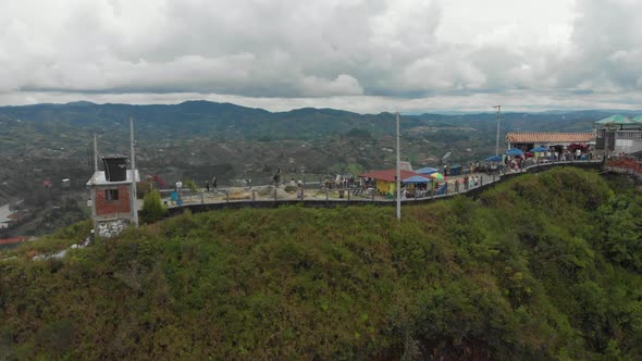 Tourists at the Top of The Rock of Guatape in Antioquia, Colombia - aerial pullback