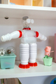Recycled toy robot made with plastic packages on shelf in classroom - PhotoDune Item for Sale
