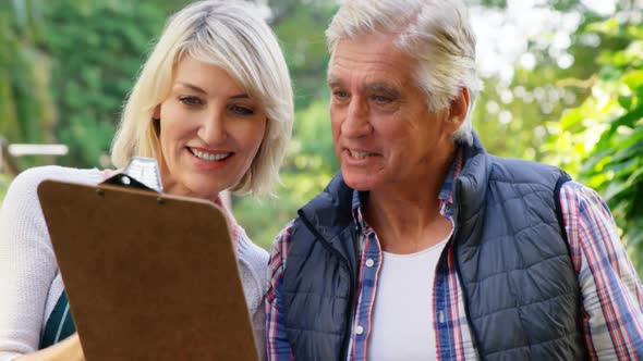 Mature couple looking at clipboard