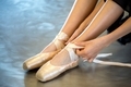 A ballerina tying her ballet slippers - PhotoDune Item for Sale