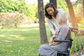 Caregiver help and care Asian senior woman patient sitting and happy on wheelchair in park  - PhotoDune Item for Sale