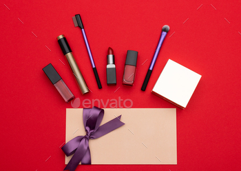 placed near blank envelope with gift certificate on vivid red background