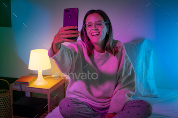 on bed with neon colors room. Technology at bed concept. High quality photo