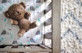 Brown teddy bear in a baby’s crib from above - PhotoDune Item for Sale