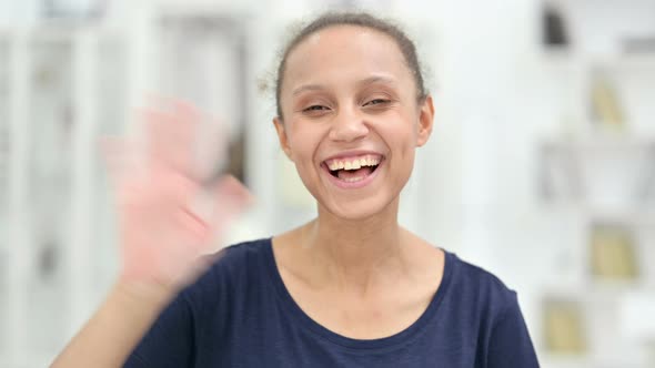 Portrait of Cheerful African Woman Waving at the Camera 