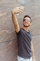 Portrait of young man standing outdoors while taking selfie - PhotoDune Item for Sale