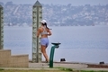 A woman jogging by the bay to get exercise in the fresh air in San Diego, California - PhotoDune Item for Sale