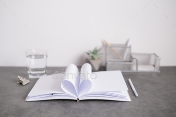 Notebook pages folded in the shape of a heart