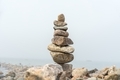 Stack of stones cairn on foggy beach - PhotoDune Item for Sale