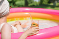 Young woman relaxing in the pool and drinking a refreshing summer cocktail. - PhotoDune Item for Sale