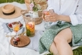 Woman in polka dot skirt holding summer cocktail on picnic. - PhotoDune Item for Sale