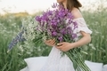 Close up of woman holding beautiful bunch of field flowers in nature. - PhotoDune Item for Sale