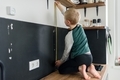 Boy child using metal tape measure at home - PhotoDune Item for Sale
