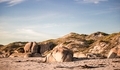 Beach rocks and dunes on a beach at sunset in Jacobsbaai, South Africa. - PhotoDune Item for Sale