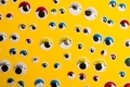 Eyes with different sizes and colors on yellow background. - PhotoDune Item for Sale