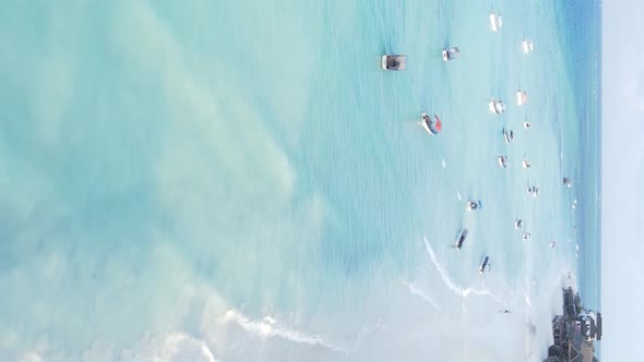 Vertical Video Boats in the Ocean Near the Coast of Zanzibar Tanzania Aerial View