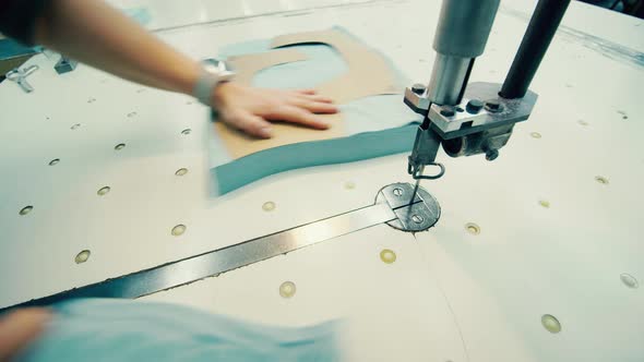 Factory Worker is Using a Template to Cut Textile