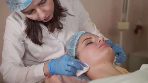 Female Patient Receiving Facial Mask in Spa Beauty Salon