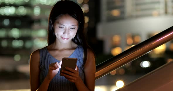 Woman using smart phone in the city 