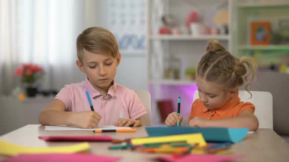 Adorable Boy and Girl Drawing by Pencils Sitting at Table, Kindergarten Leisure