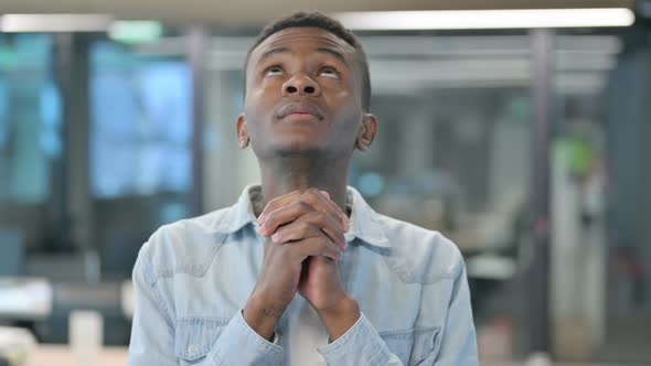 African Man Praying with Eyes Closed