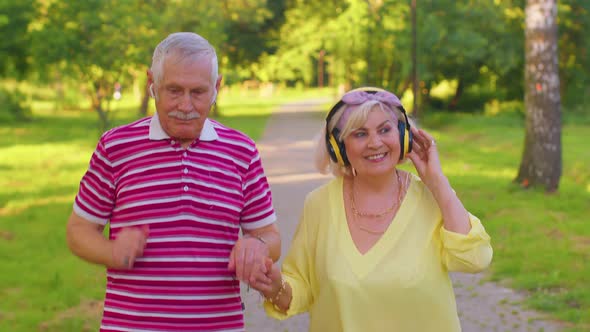 Elderly Stylish Couple Family Grandmother Grandfather Dancing Walking Listening Music in Summer Park