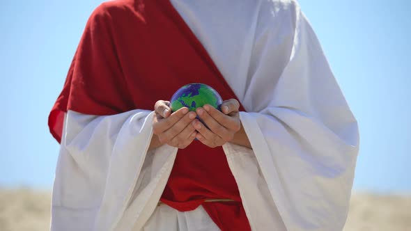 Jesus Holding Earth Planet, Love for World and Self-Sacrifice, Nature Saving