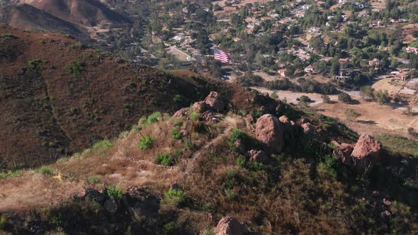 Drone Is Rising Up Above the USA Patriotic Flag Set Up in the Mountains, Summer