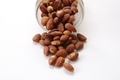 Salted and roasted almonds spilling out of glass jar. White copy space  - PhotoDune Item for Sale