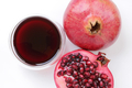 Pomegranate juice, fruit and sliced half with seeds.  - PhotoDune Item for Sale