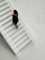 mature woman in fashionable clothes climbs the white stairs - PhotoDune Item for Sale